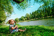 happy girl sitting on river bank happy girl sitting on river bank