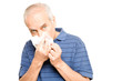 Senior man blowing nose