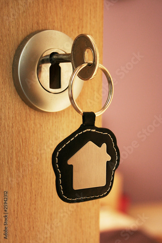 Photo: A key in a lock with house icon on it A key in a lock with house icon on it