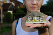 Small house in womans hand