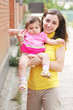 Smiling mother with little daughter closeup