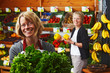 female sales assistant in front of fruit and veg stall 03 female sales assistant in front of fruit and veg stall 03