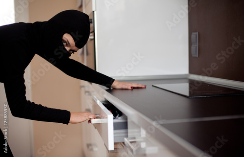 Photo: thief in black clothes and balaclava robbed home thief in black clothes and balaclava robbed home