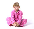 sitting on the floor little girl in pink pajamas