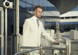 young caucasian businessman standing at the security gate