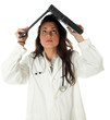 Photo: young medical woman keeping laptop on head young medical woman keeping laptop on head