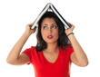 Photo: young woman in red blouse keeping book on her head young woman in red blouse keeping book on her head