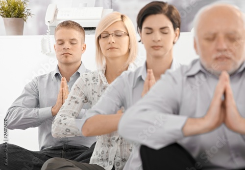 Photo: Businessteam doing yoga exercise Businessteam doing yoga exercise
