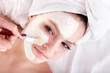 Girl with clay facial mask.