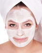 Girl with clay facial mask. Isolated.