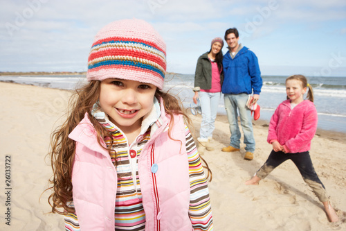 Photo: Family Walking Along Winter Beach Family Walking Along Winter Beach