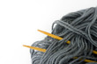 wooden needles and gray yarn, isolated on white wooden needles and gray yarn, isolated on white