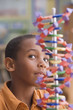 African boy studying dna model
