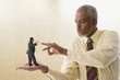 Giant businessman flicking miniature businessman