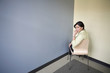 Hispanic businesswoman sitting in corner