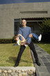 Hispanic father and son playing in front of house