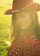 Woman wearing cowboy hat in sunlight
