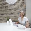 Middle-aged woman working on laptop