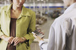 Businessman and businesswoman looking at cell phone