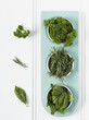 High angle view of cut herbs in jars
