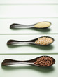 Close up of row of spoons with grains