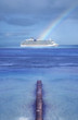 Cruise ship on horizon at end of rainbow