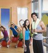 Couple standing in front of exercise group
