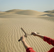 Woman holding dowsing rod in desert
