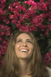 Close up of Hispanic woman looking up at flowers