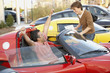 Hispanic couple buying luxury car