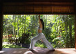 Pacific Islander woman performing yoga in jungle