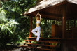 Pacific Islander woman performing yoga in jungle