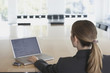 Businesswoman typing on laptop