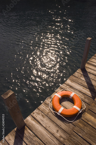 Photo: Round life preserver on wooden dock Round life preserver on wooden dock