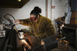 Hispanic female welder working with torch