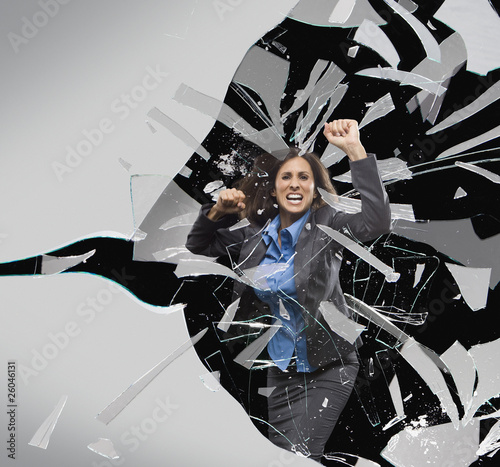 Photo: Hispanic businesswoman breaking through glass barrier Hispanic businesswoman breaking through glass barrier