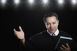 Hispanic man holding Bible and gesturing