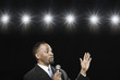 African American man holding microphone and gesturing