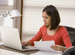 Hispanic woman paying bills online