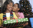 African girl giving grandmother Christmas gift
