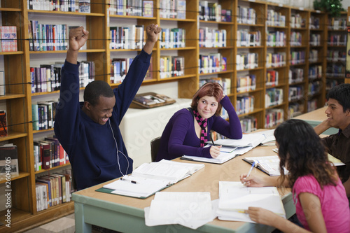 Photo: Teenage students studying in library Teenage students studying in library