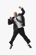 Hispanic businessman cheering and jumping in air