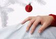 woman hand with a christmas tree in the background