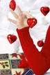 hand holding a christmas heart near to a christmas tree