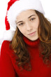 Beautiful young woman wearing santa hatisolated on white backgro