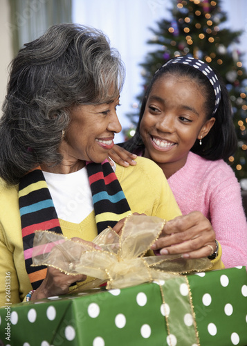 Photo: African girl giving grandmother Christmas gift African girl giving grandmother Christmas gift