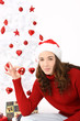 woman wearing santa hat holding an heart