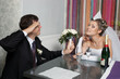 Foto: Groom saluting bride with paper garrison cap on her head Groom saluting bride with paper garrison cap on her head