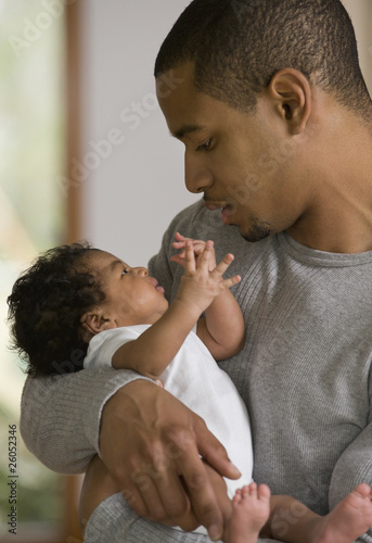 Photo: African father holding newborn baby African father holding newborn baby