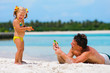 father and his cute daughter have a fun on exotic beach
